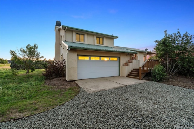 4627 Cathy Ln, Erie, CO 80516 - view of front of home featuring stucco siding, a metal roof, a garage, and driveway