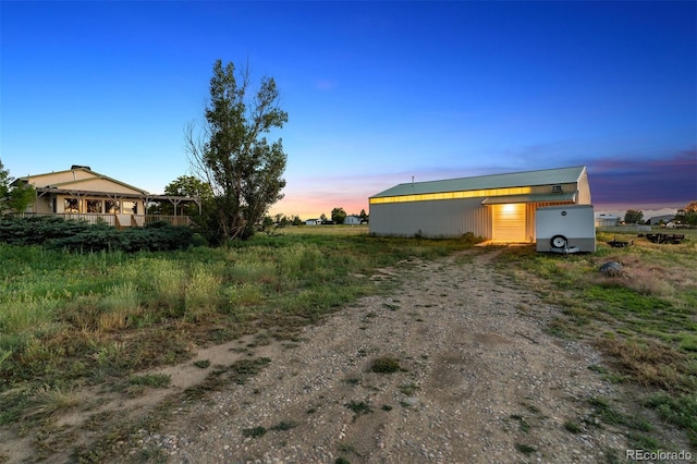 4627 Cathy Ln, Erie, CO 80516 - property exterior at dusk with dirt driveway and an outbuilding