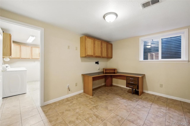unfurnished office with washing machine and dryer, baseboards, and light tile patterned flooring