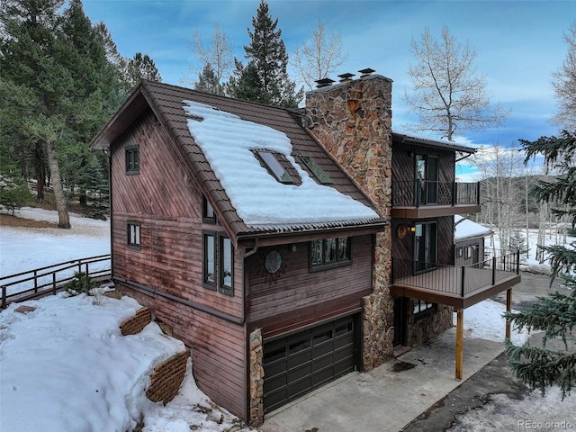 exterior space featuring a balcony and a garage