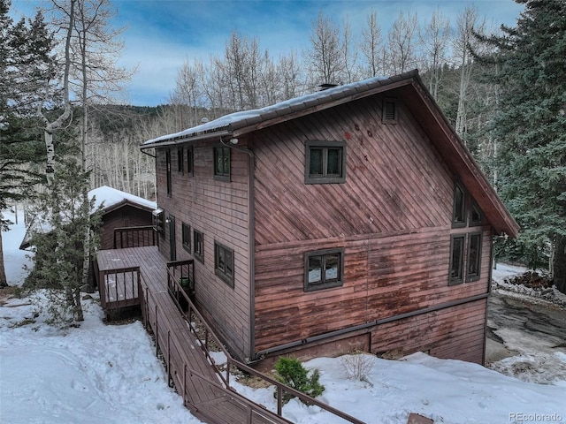 view of snow covered exterior featuring a deck