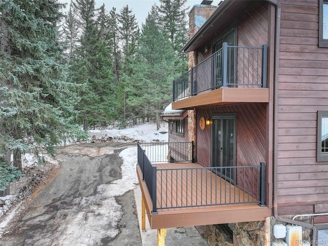 snow covered property with a balcony