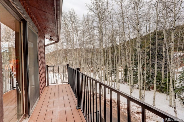 view of snow covered back of property