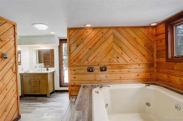 bathroom featuring plenty of natural light, wood walls, and wood-type flooring