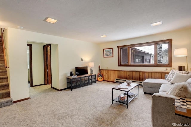 carpeted living room featuring a baseboard radiator and a textured ceiling