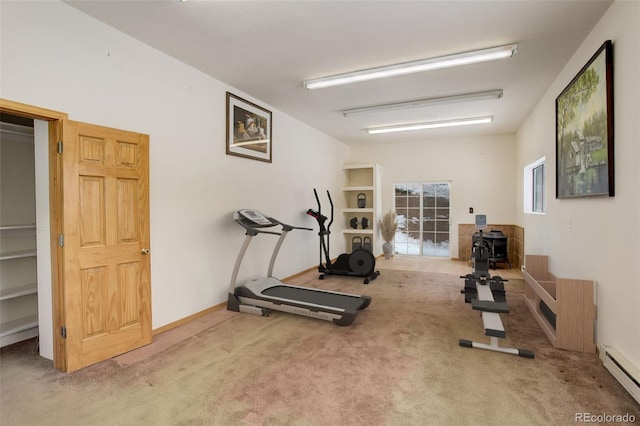 workout area with light carpet and a baseboard radiator