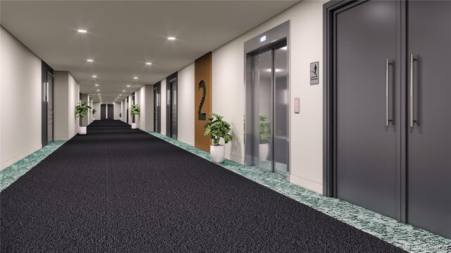 hallway with elevator and carpet floors