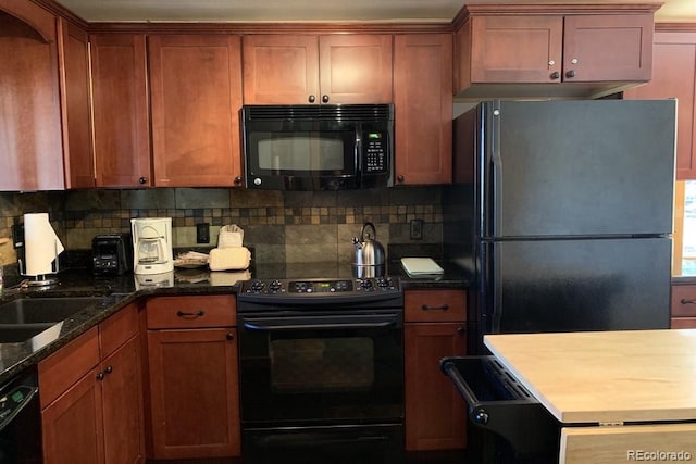 kitchen with dark stone countertops, decorative backsplash, sink, and black appliances