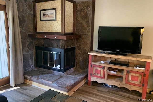 living room with hardwood / wood-style flooring and a fireplace