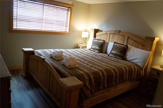 bedroom with dark hardwood / wood-style flooring