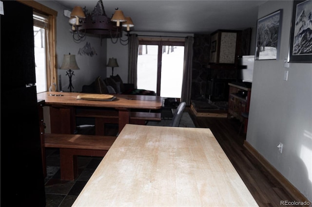 kitchen featuring dark wood-type flooring and a notable chandelier