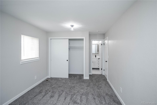 unfurnished bedroom featuring carpet and a closet