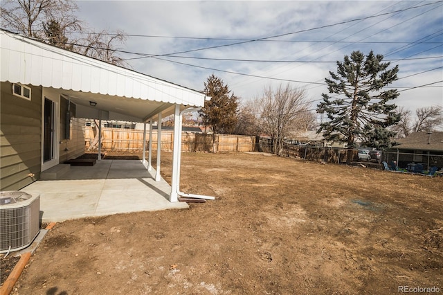 view of yard with central AC unit and a patio