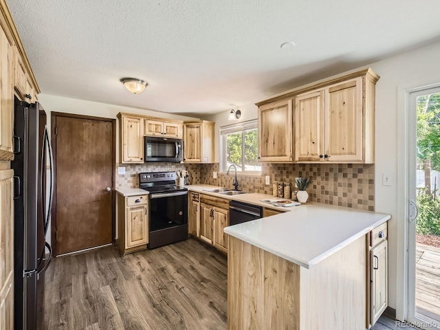 2617 Cedar Dr, Loveland, CO 80538 - kitchen featuring black appliances, a sink, light brown cabinets, a peninsula, and dark wood-style flooring
