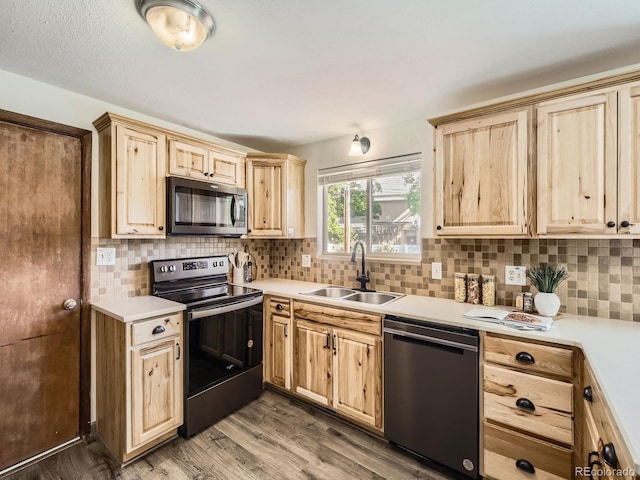2617 Cedar Dr, Loveland, CO 80538 - kitchen with stainless steel microwave, electric range, dishwasher, a sink, and light brown cabinets