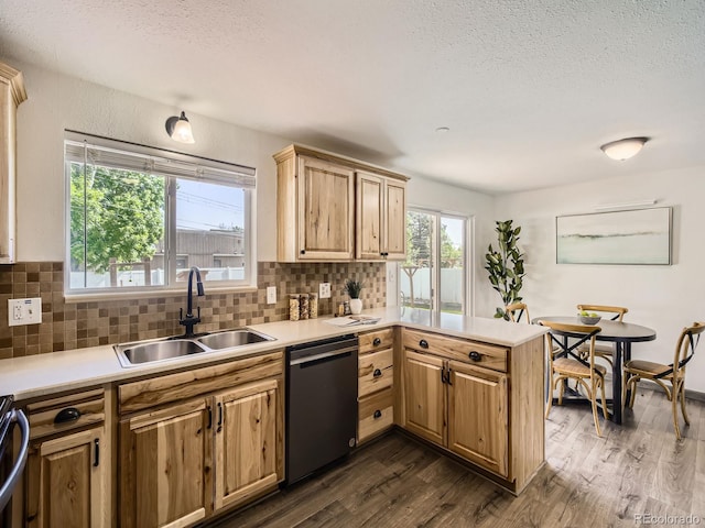 2617 Cedar Dr, Loveland, CO 80538 - kitchen with dishwasher, a sink, a peninsula, dark wood finished floors, and tasteful backsplash