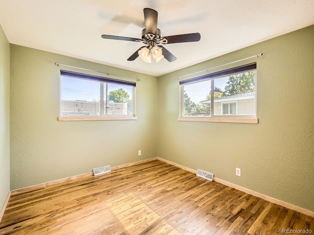 2617 Cedar Dr, Loveland, CO 80538 - empty room with wood finished floors, baseboards, a ceiling fan, and a textured wall