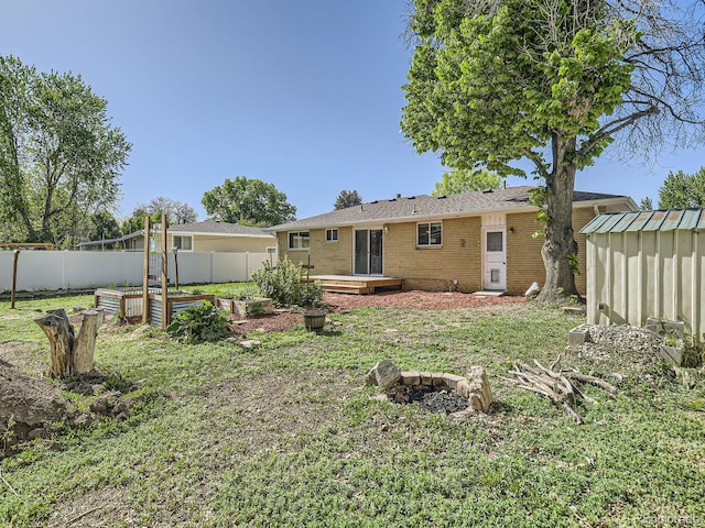 2617 Cedar Dr, Loveland, CO 80538 - back of house with brick siding, an outdoor structure, a shed, and a garden