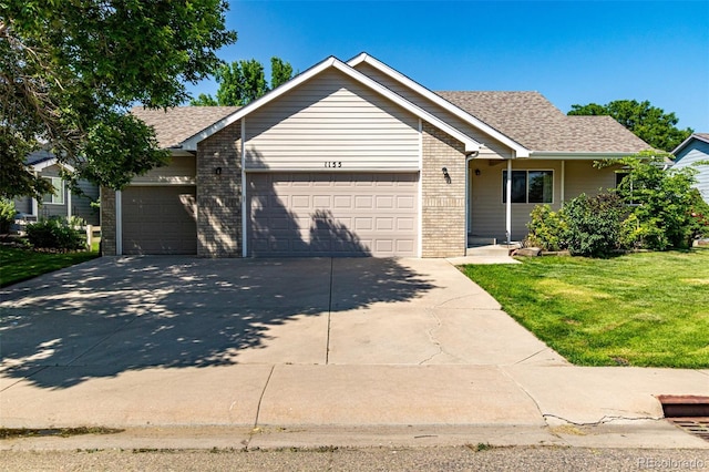 1155 Black Hawk Rd, Eaton, CO 80615 - ranch-style home with a garage, driveway, brick siding, a front yard, and a shingled roof
