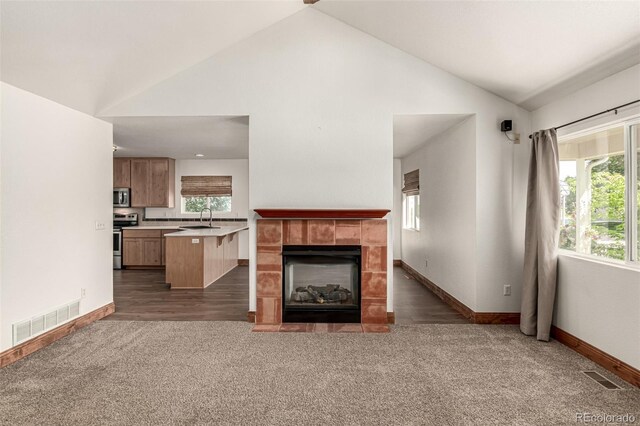 1155 Black Hawk Rd, Eaton, CO 80615 - unfurnished living room with carpet, a fireplace, and high vaulted ceiling