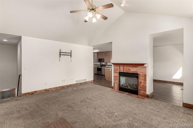 1155 Black Hawk Rd, Eaton, CO 80615 - unfurnished living room featuring ceiling fan, dark carpet, high vaulted ceiling, and a fireplace