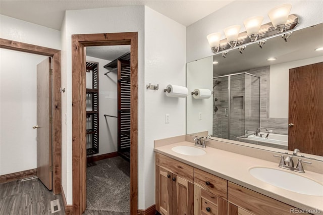 1155 Black Hawk Rd, Eaton, CO 80615 - full bath featuring a shower stall, a garden tub, double vanity, and wood finished floors