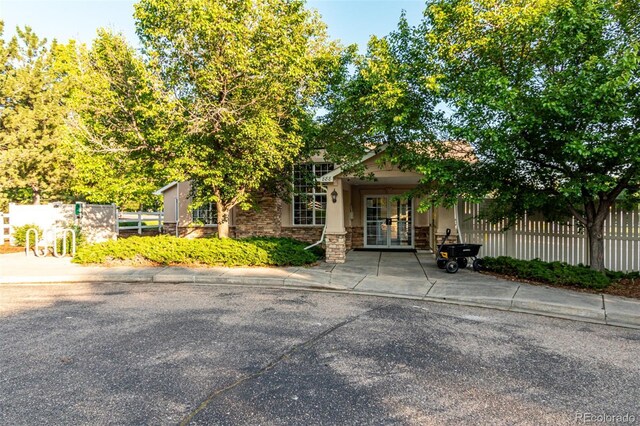 1155 Black Hawk Rd, Eaton, CO 80615 - obstructed view of property featuring french doors, stone siding, and stucco siding
