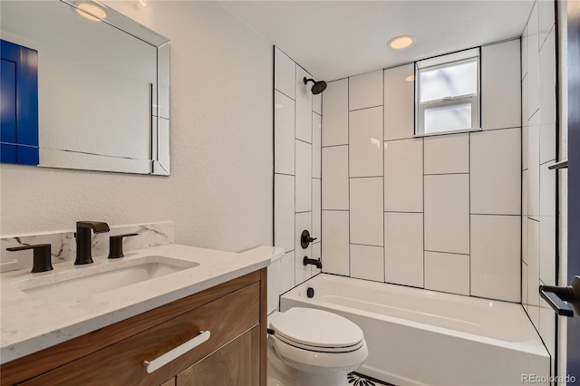 full bathroom featuring vanity, toilet, and tiled shower / bath