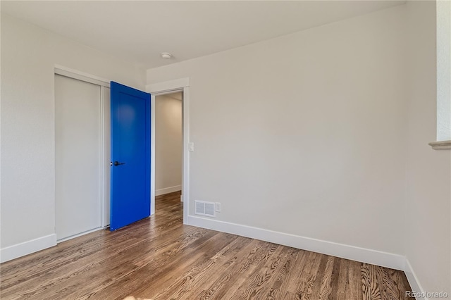 unfurnished room with hardwood / wood-style floors