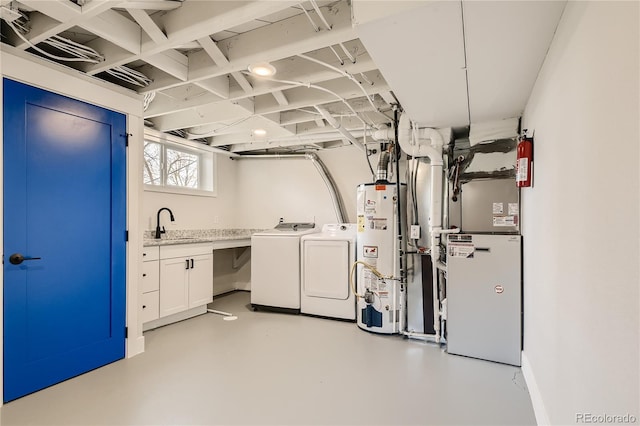 interior space featuring cabinets, gas water heater, sink, and independent washer and dryer