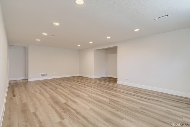 spare room featuring light hardwood / wood-style floors