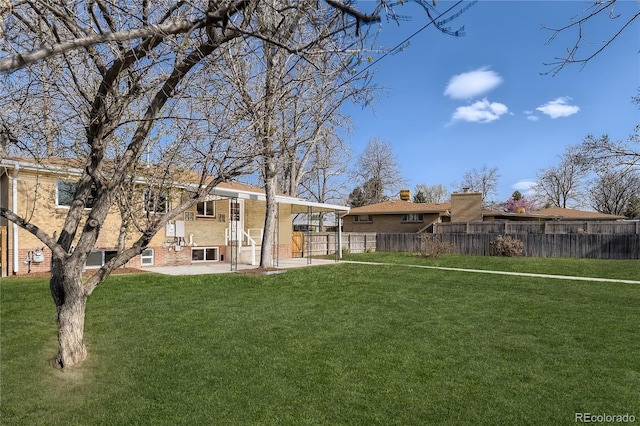 rear view of house with a yard and a patio