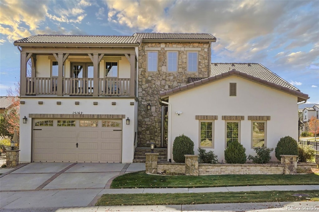 mediterranean / spanish house with a front yard and a garage