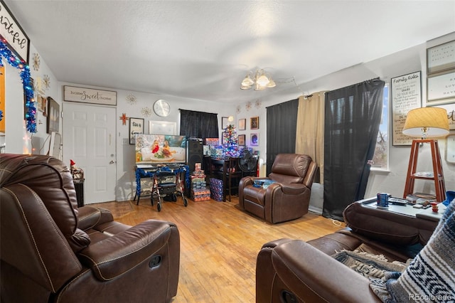 living room with light wood-type flooring and a notable chandelier