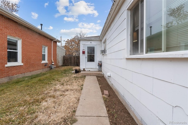 view of property exterior featuring a lawn and cooling unit