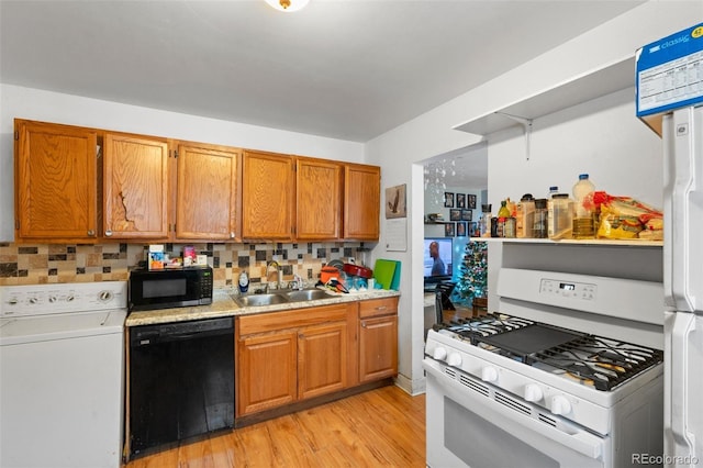 kitchen featuring tasteful backsplash, dishwasher, washer / clothes dryer, sink, and white range with gas stovetop