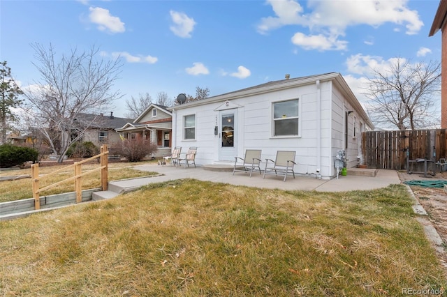 view of front of property with a front yard and a patio