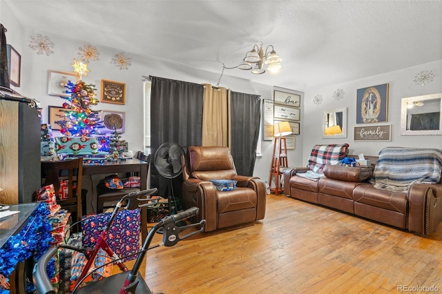 living room featuring an inviting chandelier and light hardwood / wood-style floors