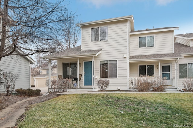 front of property featuring a garage, covered porch, and a front yard