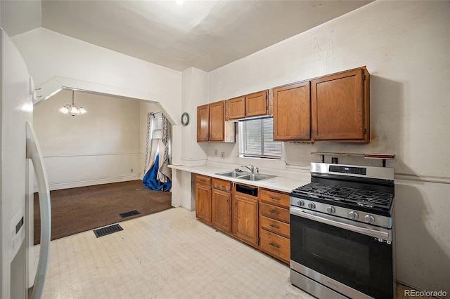 125 S Limit St, Colorado Springs, CO 80905 - kitchen with gas range, freestanding refrigerator, a sink, and brown cabinets