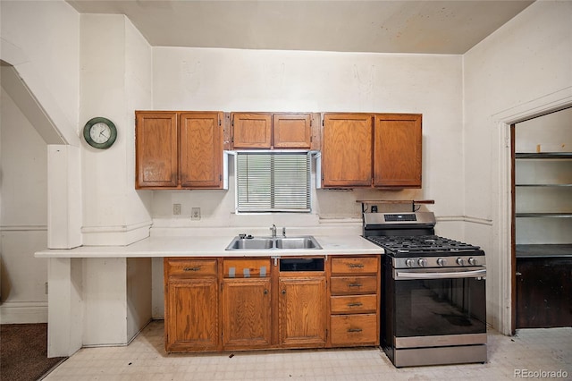 125 S Limit St, Colorado Springs, CO 80905 - kitchen with stainless steel gas range, a sink, light floors, and brown cabinets