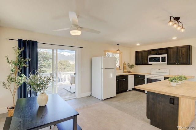 31252 County Road 384a, Buena Vista, CO 81211 - kitchen with white appliances, healthy amount of natural light, dark brown cabinetry, a sink, and recessed lighting