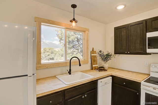 31252 County Road 384a, Buena Vista, CO 81211 - kitchen featuring white appliances, a sink, dark brown cabinets, and pendant lighting