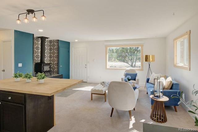31252 County Road 384a, Buena Vista, CO 81211 - living area featuring a wood stove, light carpet, and baseboards