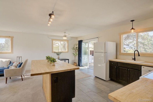 31252 County Road 384a, Buena Vista, CO 81211 - kitchen featuring a sink, white appliances, wood counters, hanging light fixtures, and dark brown cabinetry