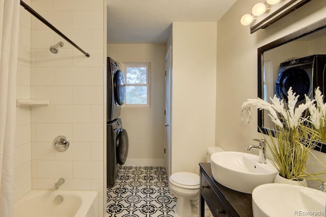 31252 County Road 384a, Buena Vista, CO 81211 - bathroom with stacked washer and clothes dryer, baseboards, shower / bath combination with curtain, toilet, and vanity