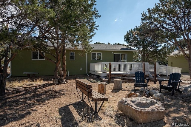 31252 County Road 384a, Buena Vista, CO 81211 - rear view of house with stucco siding, a deck, and a fire pit