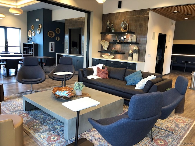 living area with a high ceiling and wood finished floors