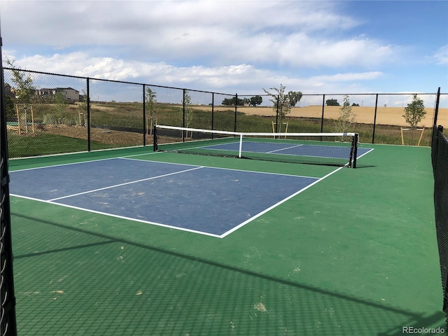 view of tennis court with fence