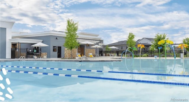 pool with a patio area and fence